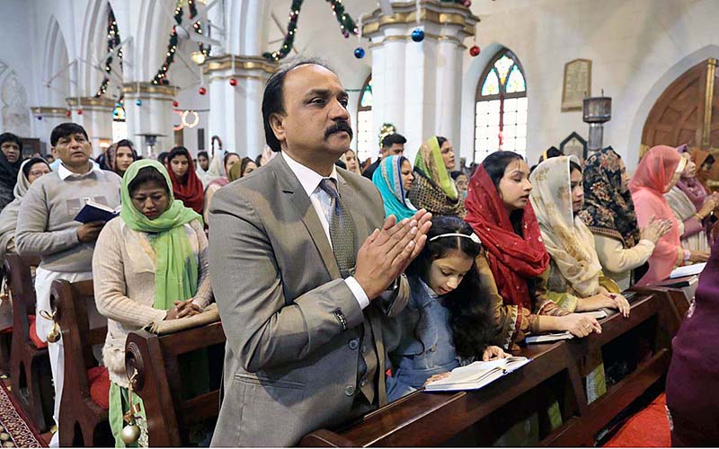 People from Christian community are busy in their religious rituals during Christmas service at Saint John's Cathedral Church