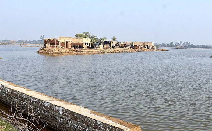 A view of submerged houses after four months of flash flood water as millions of houses and roads damaged and washed away due to deadly flood hit the area of Dil Murad Khokhar Village near City