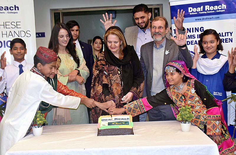 First Lady Samina Arif Alvi cutting cake at Deaf Reach Schools Training Centers