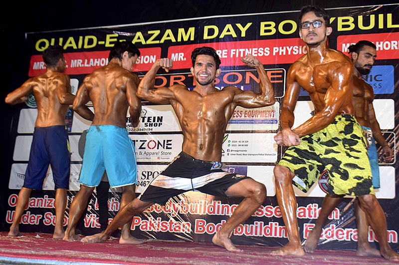 Bodybuilders demonstrating during Quaid-e-Azam Day Bodybuilding Championship 2022 organized by Bodybuilding Association at Mafal Theater