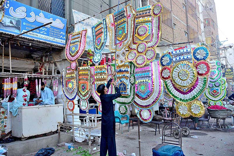Vendors displaying currency garlands to attract the customers at Flower Market