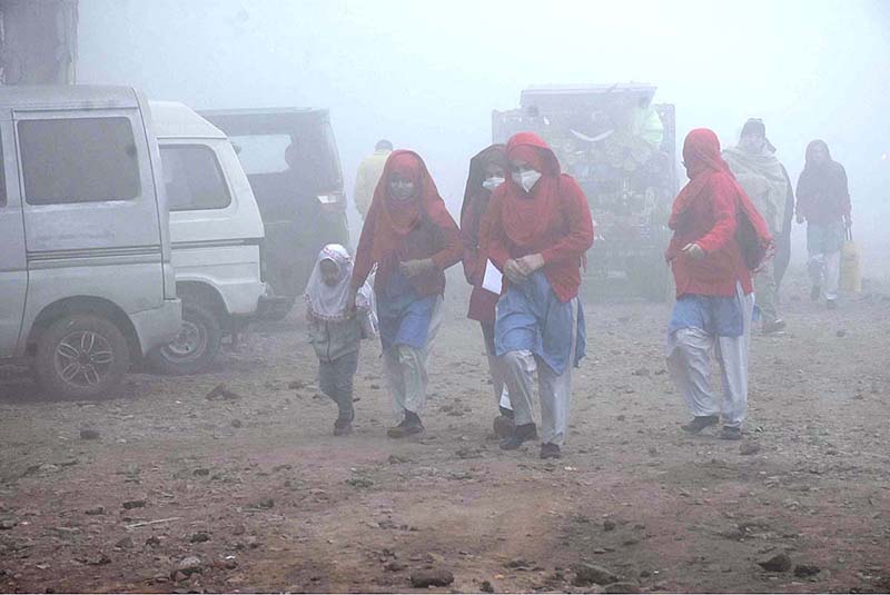Students on the way to school during heavy fog in the city