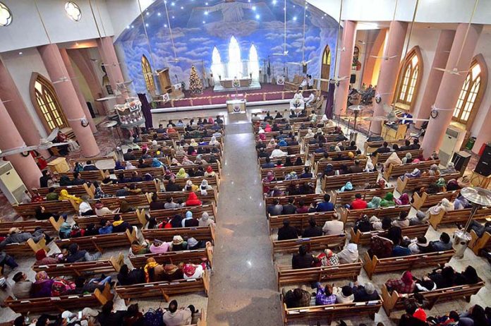 People from Christian community performing their religious rituals during special service on Christmas Day at St Peter’s Church.