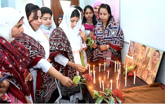 Principal Dr. Ghulam Sakina Gaad along with students lighting candles to pay tribute to former Prime Minister Shaheed Mohtarma Benazir Bhutto in connection with upcoming her 15th death anniversary at Public Health School during a function