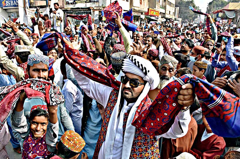 Girls enjoy on the cultural music during the occasion of Sindhi Cultural Day outside the Karachi Press Club.