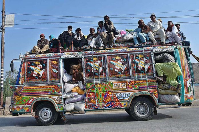 A large number of passengers traveling on the rooftop of a passenger bus at Larkana-Qambar Road may cause any mishap and needs the attention of concerned authorities