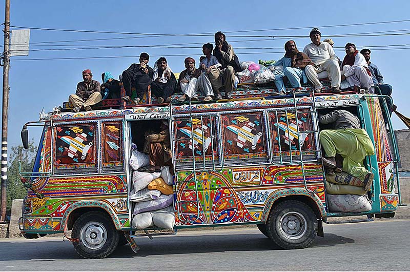A large number of passengers traveling on the rooftop of a passenger bus at Larkana-Qambar Road may cause any mishap and needs the attention of concerned authorities
