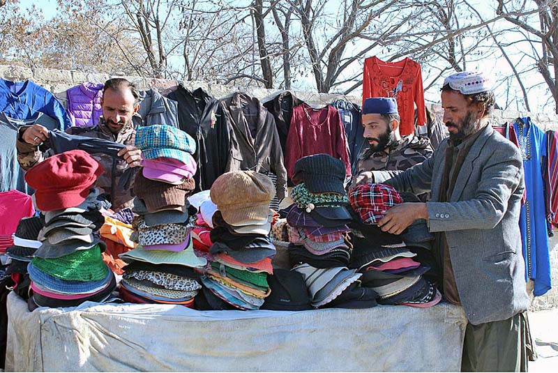 Vendor selling warm cap for winter season on Railway Station Road