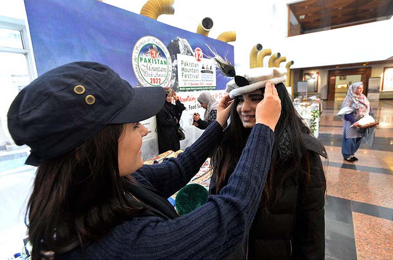 A girl is wearing traditional (pakol) cap during closing ceremony of 12th Pakistan Mountain Festival organized by Devcom-Pakistan and Pakistan National Council of the Arts