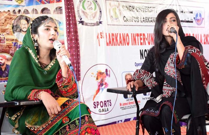 Students singing a cultural song during Cultural Programme in connection with upcoming Sindhi Ajrak Topi Culture Day at Sindh University Campus