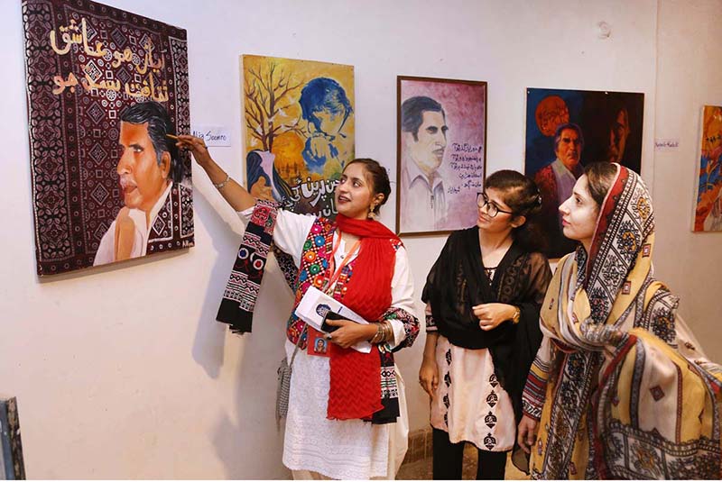Visitors viewing the paintings displayed at the 8th edition of Ayaz Melo organized by Khanabadosh Writers Café at Sindh Museum