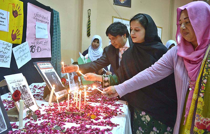 Principal Khubaib Girls School and College Sarwat Ansar and Vice President Pakistan Chambar of Education lighting candles to tribute martyrs of APS Peshawar at Khubaib Girls School and College