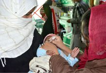 A health workers is administering Polio drops to children during Polio Campaign
