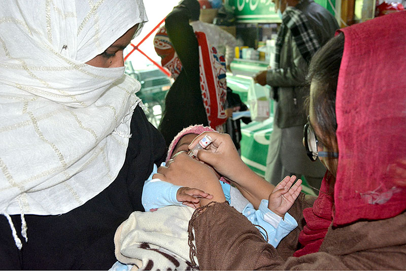 A health workers is administering Polio drops to children during Polio Campaign