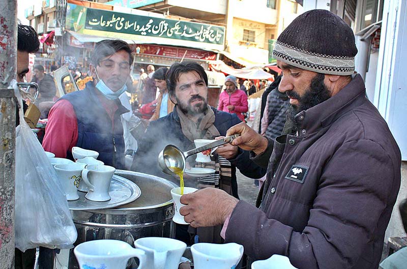 Shopkeepers torching wood in winter to protect from cold breeze