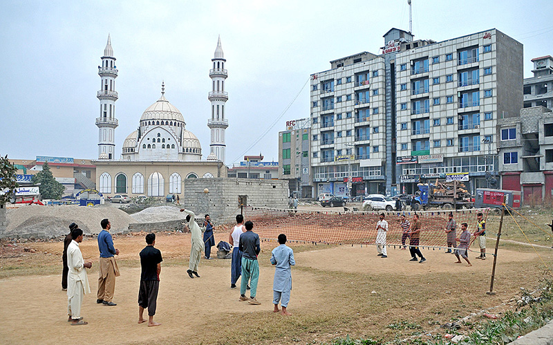 Youngsters playing volleyball in a local park at Bhara Kahu.