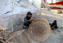 A worker making traditional baskets at his workplace