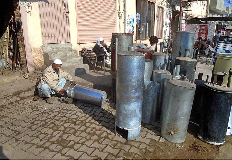 A worker making gas geyser at Railway Station Road