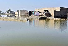 A view of submerged houses after flash flood water as millions of houses and roads damaged and washed away due to deadly flood hit the area of Brohi Mohalla near Qambar City