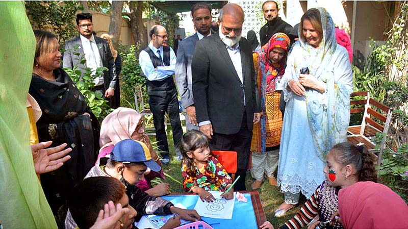 Begum Samina Arif Alvi taking a tour of the facilities at the Raunak-e-Islam school for the rehabilitation and education of special persons.