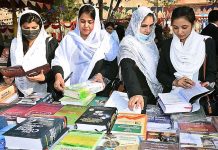 Lawyers viewing displayed books on a stall during 2nd Law Books Festival at District and Sessions Court arranged by District Bar Association