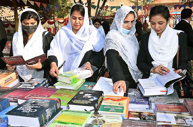 Lawyers viewing displayed books on a stall during 2nd Law Books Festival at District and Sessions Court arranged by District Bar Association