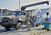 Workers busy in laying wire at Feroze Pur Road