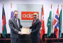 Lt. Gen. Inam Haider Malik Chairman NDMA presenting coffee table book of NDMA to Hans Guttman, Executive Director of Asian Disaster Preparedness Centre