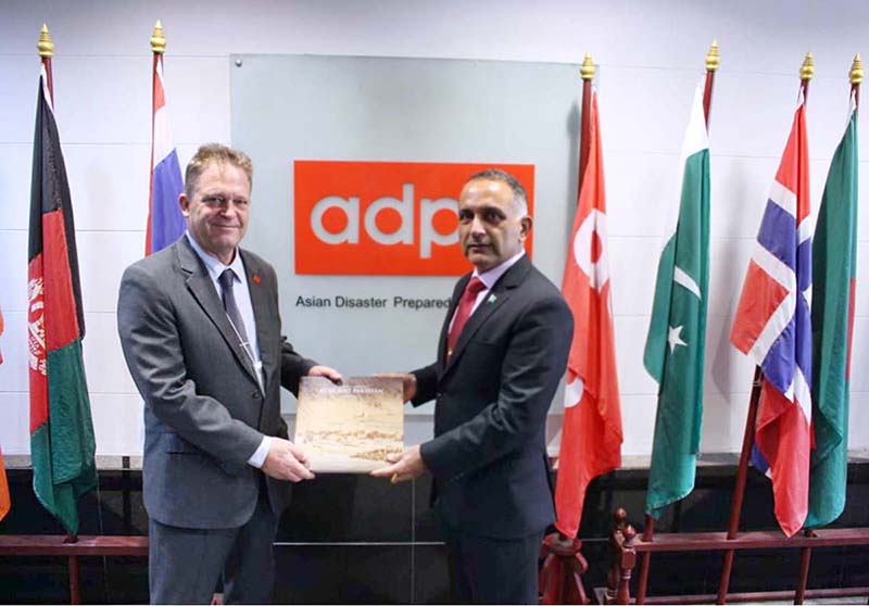 Lt. Gen. Inam Haider Malik Chairman NDMA presenting coffee table book of NDMA to Hans Guttman, Executive Director of Asian Disaster Preparedness Centre