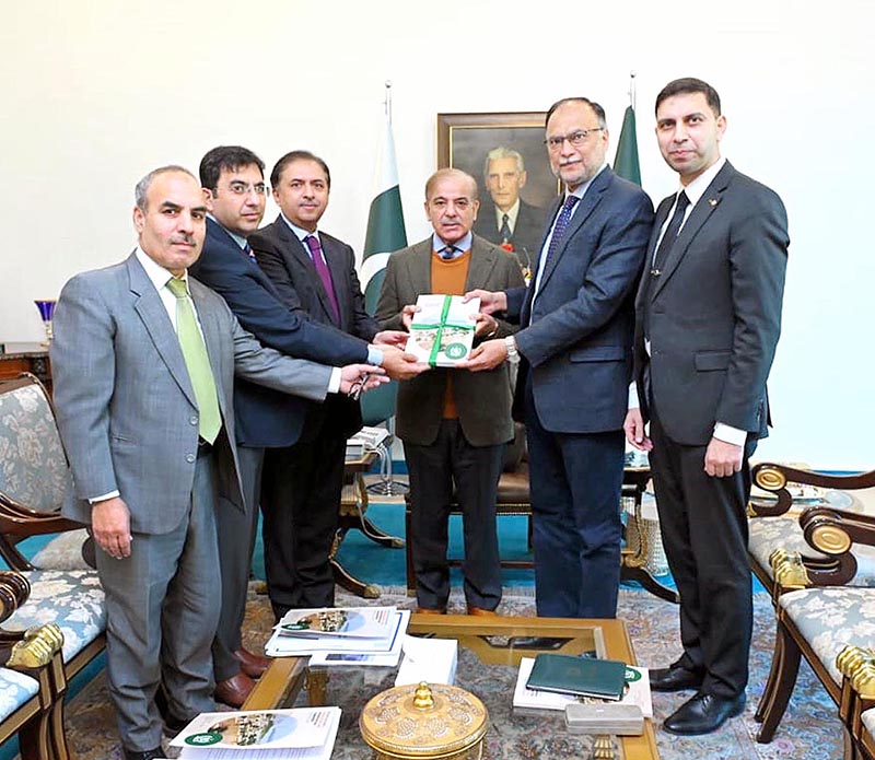 Federal Minister for Planning, Development and Special Initiatives, Mr. Ahsan Iqbal presenting a copy of Resilient, Recovery, Rehabilitation and Reconstruction (4RF) Report to Prime Minister Muhammad Shehbaz Sharif