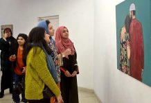 Visitors taking keen interest in painting exhibition titled " Rebel Rebel" organized by Alhamra Arts Council.