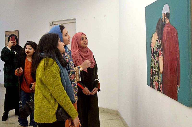 Visitors taking keen interest in painting exhibition titled " Rebel Rebel" organized by Alhamra Arts Council.