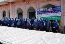 Students viewing translated Quran Pak which is 40 feet long, 8.6 feet wide and composed of 31 pages, prepared by Imtiaz Ahmad Shah Noorani of Faisalabad during One Day Exhibition at Govt. Post Graduate Islamia College