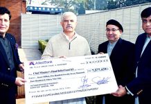Peshawar Development Authority (PDA) Officials presenting cheque to Chief Minister Khyber Pakhtunkhwa Mahmood Khan for Flood affectees