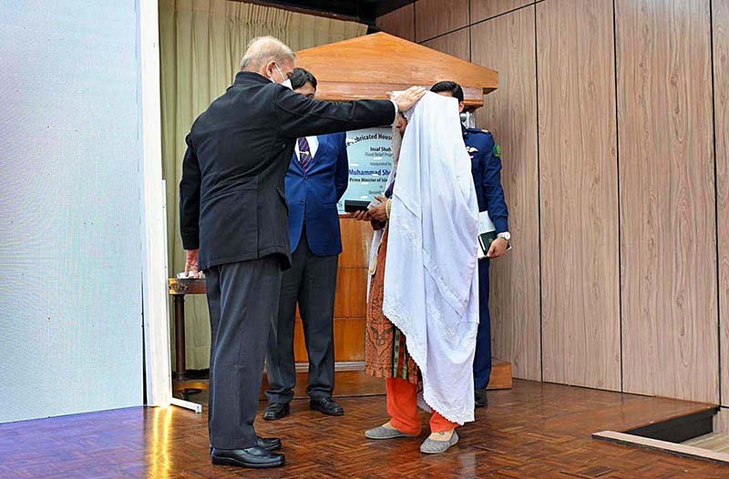 Prime Minister Muhammad Shehbaz Sharif distributes keys of the newly built houses among the flood affectless of Tank at the inaugural ceremony of Insaf Shah Pre-Fabricated Housing Project donated for the Flood Affectees of Tank by Menzies Aviation Group and SPARS Group.