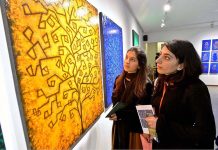 Girls visiting and viewing art work exhibition by Nazia Ejaz at Tanzara Gallery