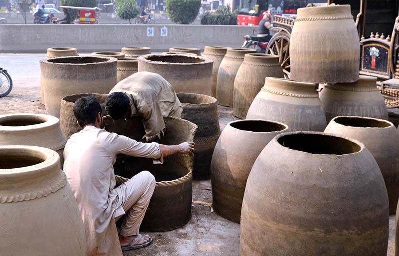 A potter busy in making traditional ovens (Tandoor) at his workplace in the outskirt area of the city