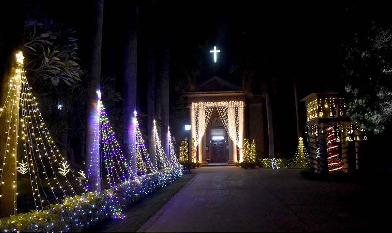 Sialkot's historic church at Christian Hospital is decorated with colorful lights on the eve of Christmas