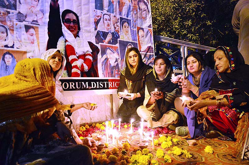 PPP workers lit up candles in front of Shaheed Muhtarma Benazir Bhutto portrait in connection with 15th death Anniversary of Shaheed Muhtarma Benazir Bhutto at post office road.