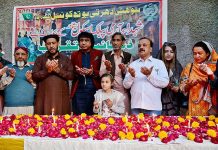 Members of Sohni Dharti Youth Council members offering Dua after lit the candles in commemoration of martyrs of Army Public School Peshawar outside Press Club
