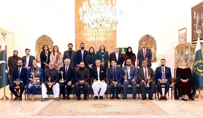 President Dr. Arif Alvi in a group photo with award-winning entrepreneurs who performed well in the field of IT and Emerging Technologies, at Aiwan-e-Sadr