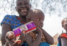 A woman receives medication to treat her four-year-old daughter who is suffereing from malaria in Jonglei State, South Sudan-UNICEF