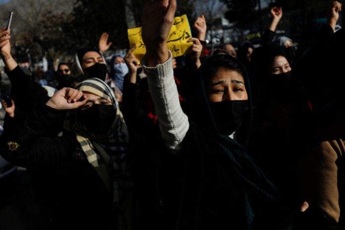 Afghan women chant slogans in protest against the closure of universities to women by the Taliban in Kabul UN rights chief urges Taliban to 'immediately' reverse restrictions on women