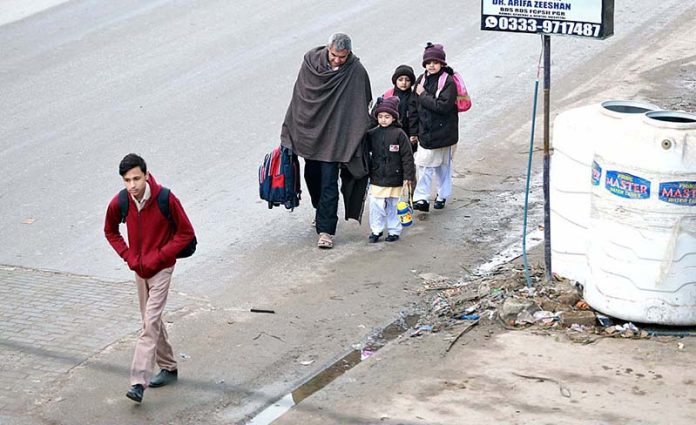 Children on the way to their school as educational institutions are reopened after winter vacations