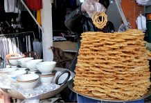 A shopkeeper arranging sweet items (Jalebi) to attract the customer at Aabpara