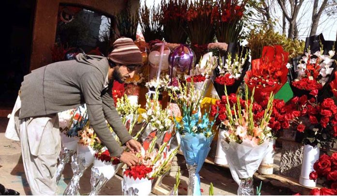 A vendor displaying flower bouquets to attract customers at flower Market