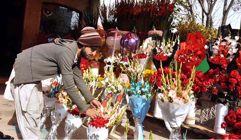 A vendor displaying flower bouquets to attract customers at flower Market.