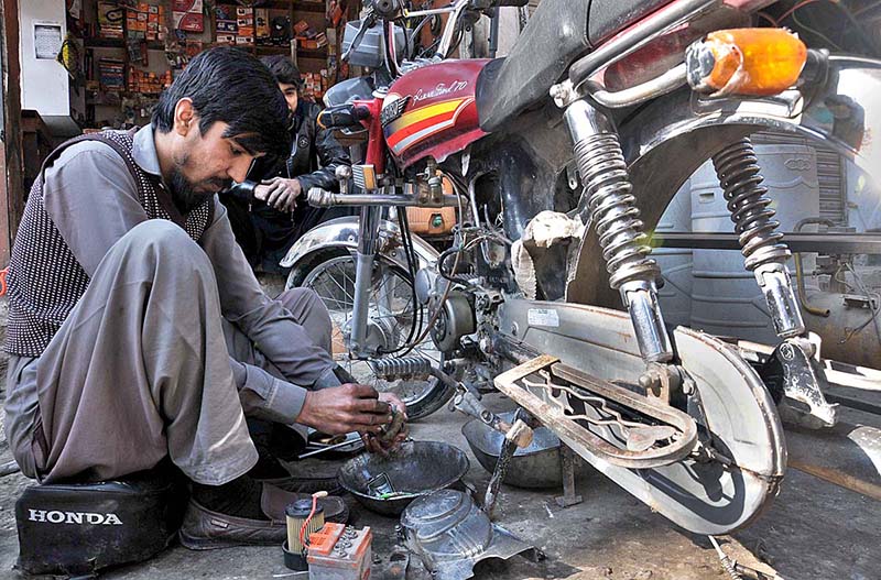 A mechanic busy in repairing motorcycle at Gouri VIP.