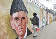 An artist paints the portrait of Quaid e Azam on the wall of IMCG F-6 for maintaining beautification of the city