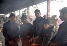 People standing around fire, warming themselves as the temperature dropped in Federal Capital